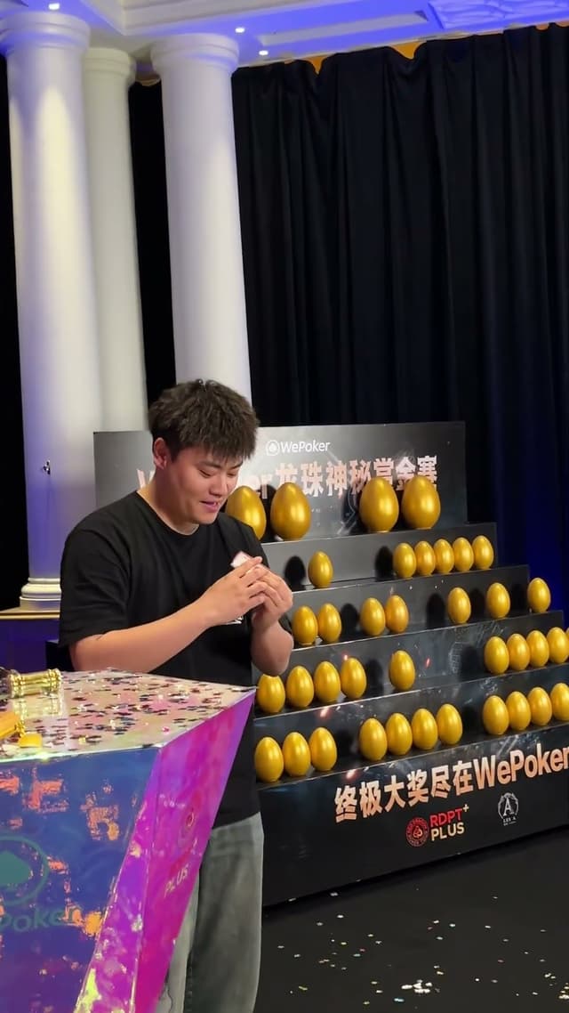 Red Dragon Plus Championship winner Jieming Xu asked one of the security staff to help crack the egg