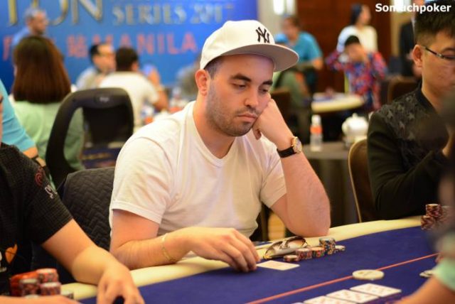 Bryn Kenney playing poker wearing a white cap