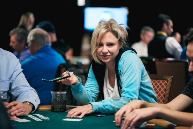 Jennifer Harman playing poker and holding glasses