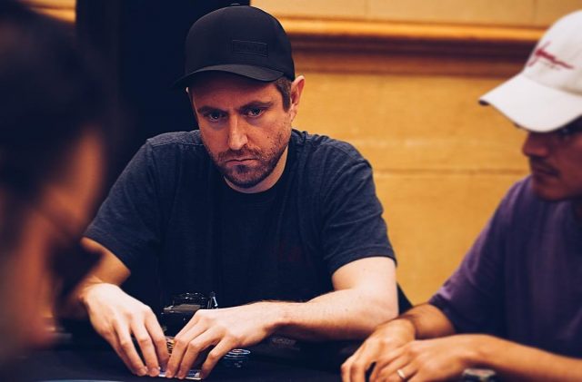 Andrew Neeme playing poker wearing a black cap